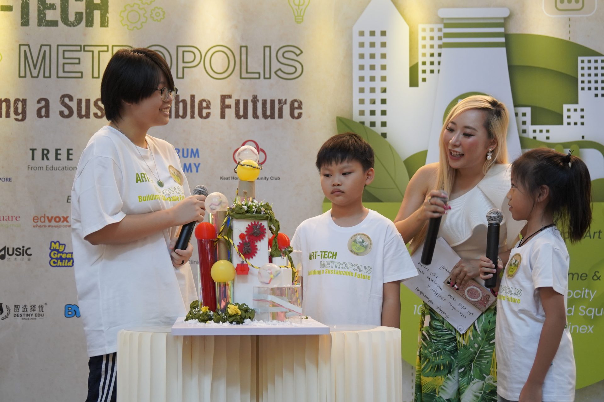 Students and mentor around a colourful kinetic art model