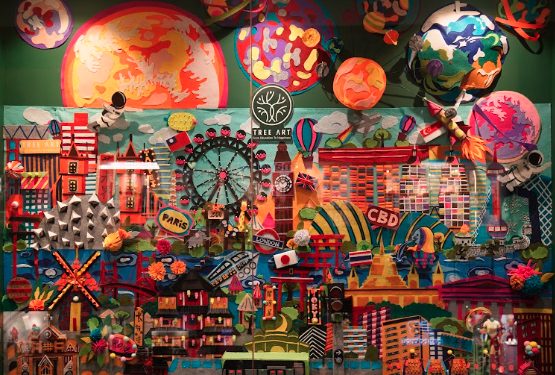 Colourful mixed-media collage wall of world landmarks at a Tree Art campus